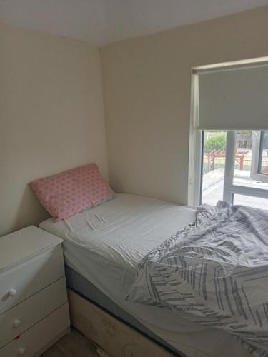 a small bedroom with a bed and a window at Cozy stay in Dublin