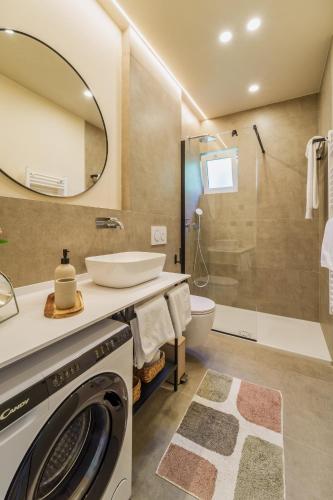 a bathroom with a washing machine and a sink at Apartment Na broju3 in Krk