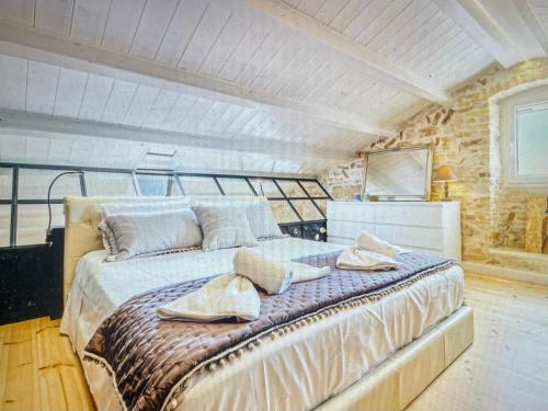 a bedroom with a large bed with towels on it at Amazing apartment with view in Kanoni