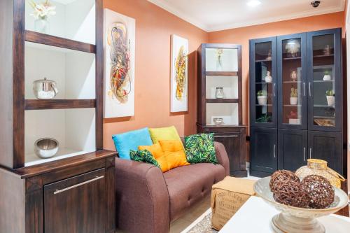 a living room with a couch and a table at Luxe Oasis Palma in Quatre Bornes