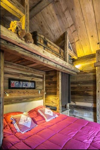 a large wooden bed in a room with a wooden ceiling at Squaw Peak in Morzine
