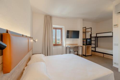 a hotel room with a bed and a desk at Hotel Sangallo in Monte San Savino