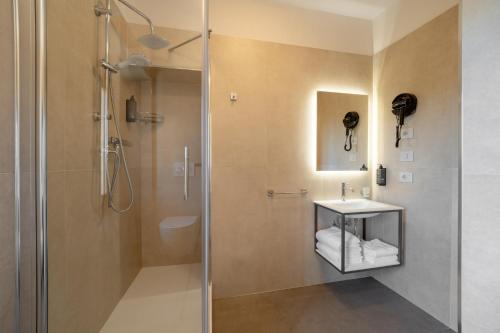 a bathroom with a shower and a sink at Hotel Sangallo in Monte San Savino