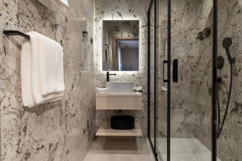 a bathroom with a sink and a shower at Hotel Aquarius Dubrovnik in Dubrovnik