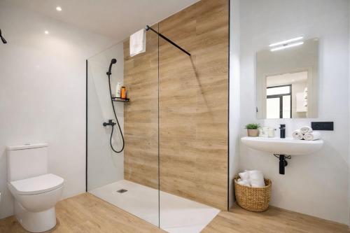 a bathroom with a shower with a toilet and a sink at LEMIGA SUiTE VALENCIA in Valencia