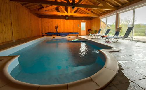 a swimming pool in a house with a pool at Chalet Bien-être, Piscine, Spa in La Chapelle-dʼAlagnon