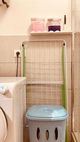 a bathroom with a toilet with a shelf on the wall at Casa Di Luce con Parcheggio Privato Interno Gratuito in Montesilvano