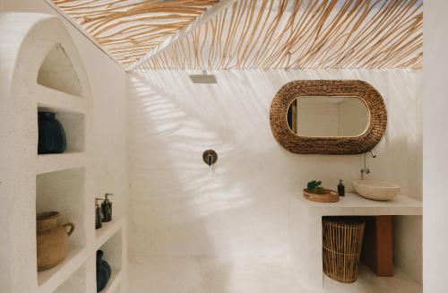 a bathroom with a mirror on the wall at Tanahi Gili Air in Gili Islands