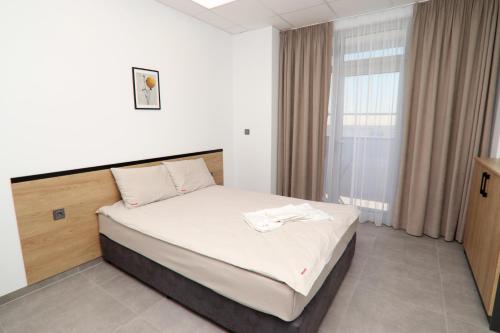 a bedroom with a bed in a room at Хотел КО НИ КО in Stara Zagora