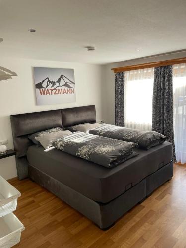 a large bed in a room with at Schuhhaus Biberger - Fewo Lukas in Schönau am Königssee