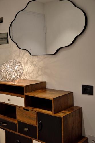 a room with a dresser with a mirror on the wall at Junior Suite agli Archetti in Torri del Benaco