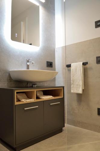 a bathroom with a sink and a mirror at Junior Suite agli Archetti in Torri del Benaco