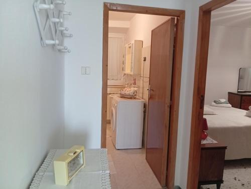 a room with a small refrigerator and a room with two beds at Casa Relax in Carunchio