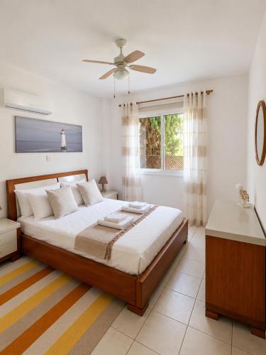 a bedroom with a bed and a ceiling fan at Athena Apartment in Polis Chrysochous
