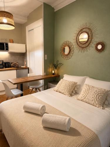 a bedroom with a bed with two towels on it at l'Ecrin Bellevue in Aix-les-Bains
