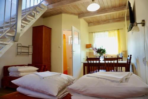 two beds in a room with a staircase at Arkadia - Amber in Jantar