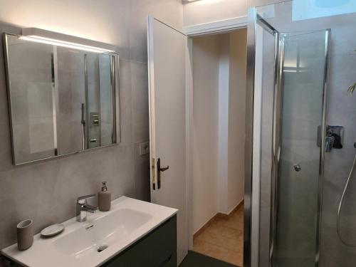 a bathroom with a sink and a shower at Total Relax Home by Holiday World in Framura