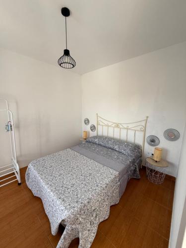 a bedroom with a bed with a patterned blanket at La casita de llanda in Suances