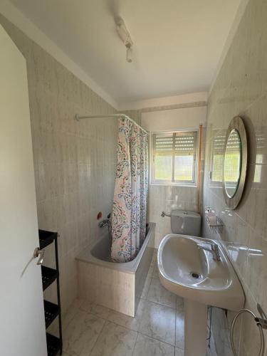 a bathroom with a sink and a bath tub and a sink at La casita de llanda in Suances