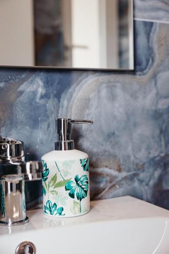 a bottle of soap sitting on a bathroom sink at Tenuta Mari in Castelnuovo Cilento