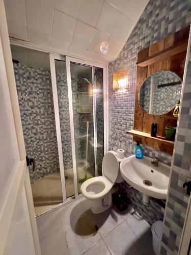 a bathroom with a toilet and a sink at Amzil Surf House in Aourir