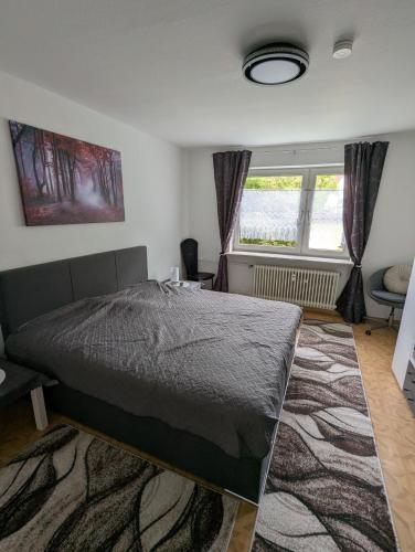 a bedroom with a bed and a window at Holm in Melsungen