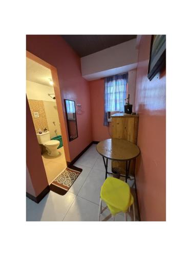 a small room with a table and a toilet at Mayon Lodging House in Legazpi