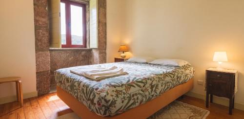 a bedroom with a bed and a window at Spacious House in Seia with Stunning Mountain Views, 150 m² in Seia