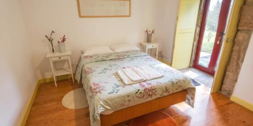 a bedroom with a bed with two towels on it at Spacious House in Seia with Stunning Mountain Views, 150 m² in Seia