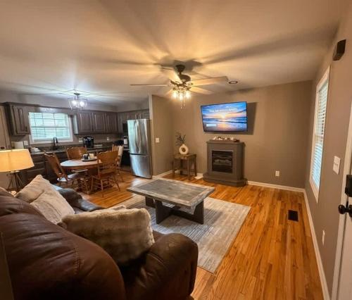a living room with a couch and a table at Mountain Hideaway at Cabins in the Clouds in Rising Fawn