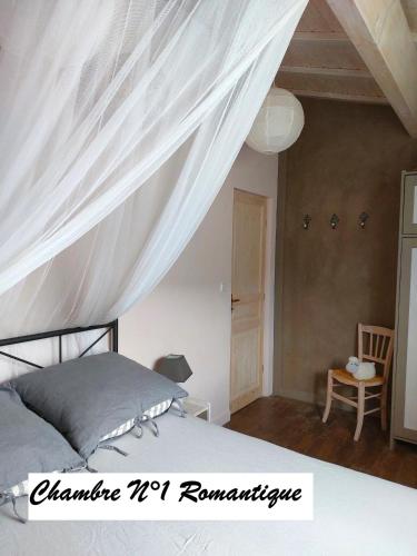 a bedroom with a bed with a canopy at Chambres d'hôtes " Casa della Felicità " in La Roche-sur-le-Buis