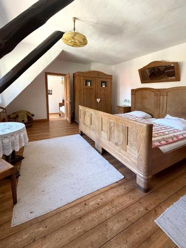 a bedroom with a large bed and wooden floors at Lieblingsnest in Bad Fallingbostel