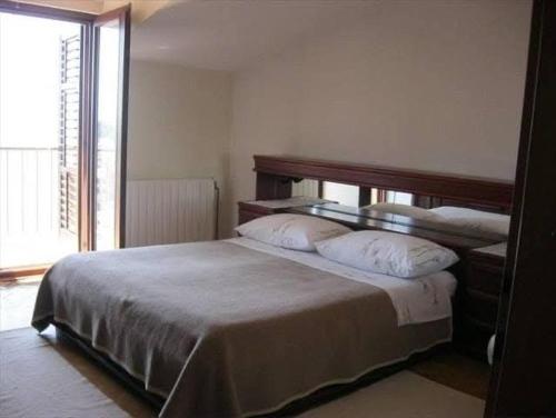 a bedroom with a large bed with two pillows at Stanka in Podgora