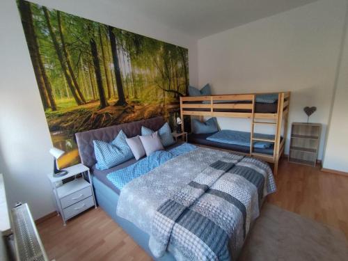 a bedroom with a bed and a painting on the wall at NEU! Fereinwohnung Greim in Lengenfeld