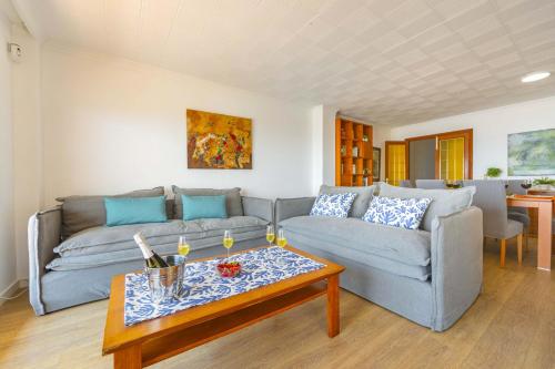 a living room with a couch and a coffee table at Seafront Cala Ratjada Apartment in Cala Ratjada