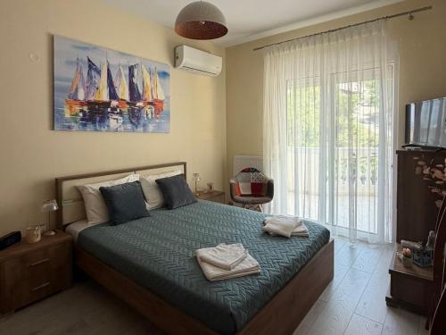a bedroom with a large bed with towels on it at Luxury View in Iraklitsa
