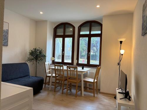 a living room with a table and chairs and a couch at City Saint-Louis in Saint-Louis
