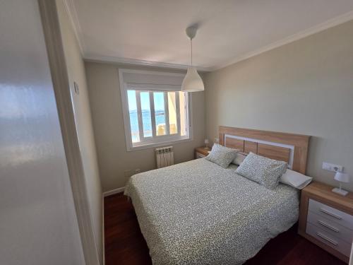 a bedroom with a bed and a window at Palmeira in Ribeira
