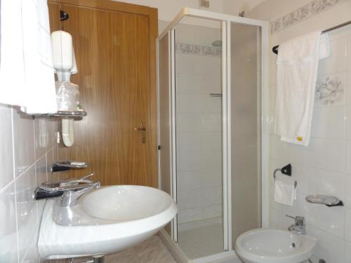 y baño con lavabo y ducha. en Albergo Ristorante Grigna, en Mandello del Lario