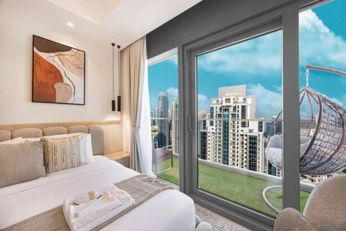 a bedroom with a bed and a large window at Downtown Dubai's Highest Infinity Pool, Paramount Hotel Midtown in Dubai