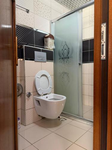 a bathroom with a toilet and a shower at Haros Apart Hotel in Uzungöl