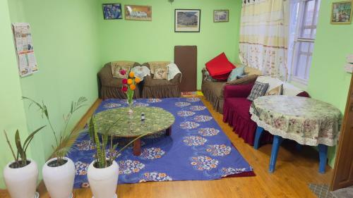 a living room with a table and a couch at Local feeling in Nepal in Bhaktapur