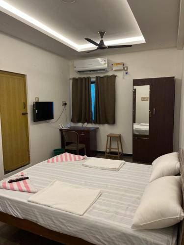 a bedroom with a large bed with a ceiling at jambu's residence in Karūr
