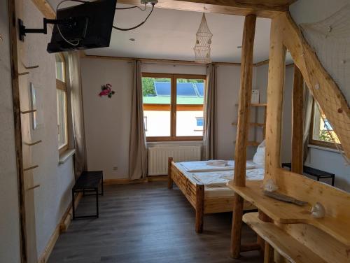a room with a bed and a large window at Pension Bomätscher in Königstein an der Elbe