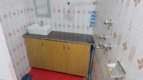 a small bathroom with a sink and a mirror at Local feeling in Nepal in Bhaktapur