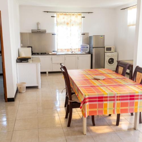 a kitchen with a table with a colorful table cloth on it at Elegant Apartment in Trou aux Biches / 125 m² / Mountain View in Trou aux Biches