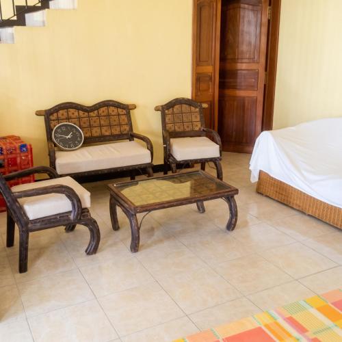 a room with two chairs and a table and a bed at Elegant Apartment in Trou aux Biches / 125 m² / Mountain View in Trou aux Biches