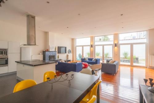 a kitchen and living room with a table and chairs at Spacious House with Large Garden in Jette in Brussels