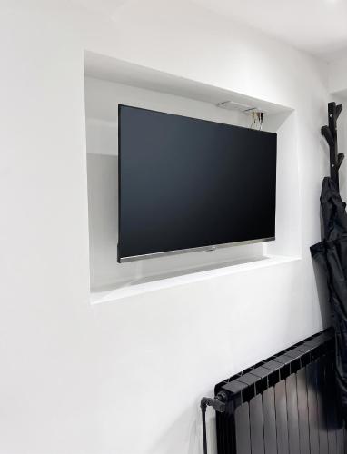 a flat screen tv hanging on a wall at House with Private Pool in Spindoli - 100 m² in Spindoli