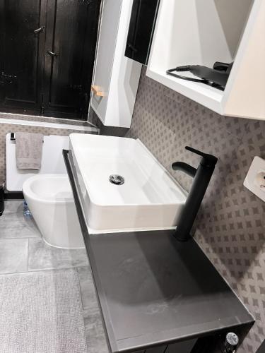 a bathroom with a white sink and a toilet at House with Private Pool in Spindoli - 100 m² in Spindoli